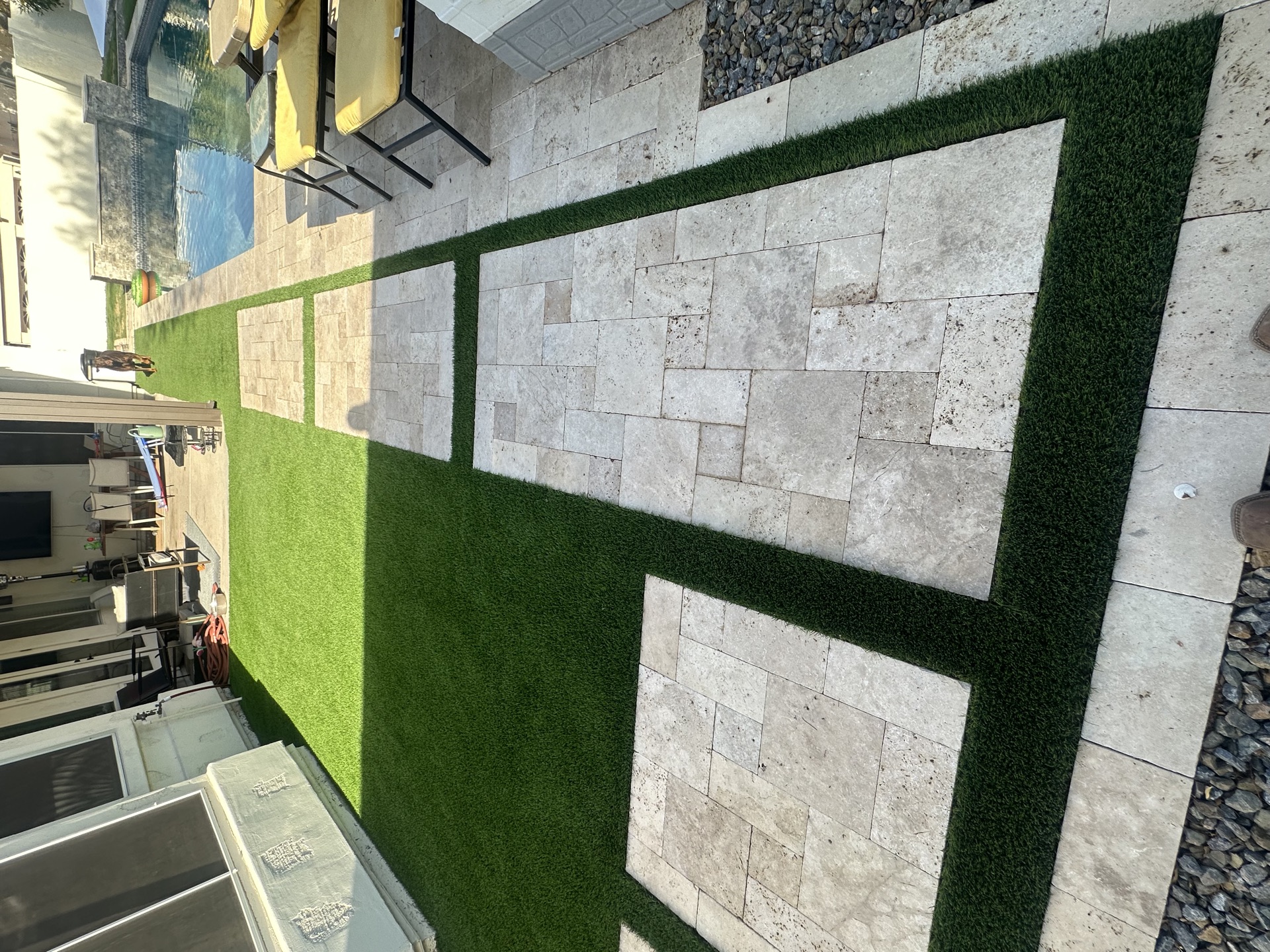 Turf and paver grid design with outdoor kitchen